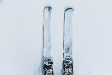 Two skis parallel in snow from above