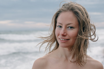 Young woman on the beach looking at camera