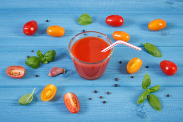 Tomato juice and vegetables with spices on boards, concept of healthy nutrition