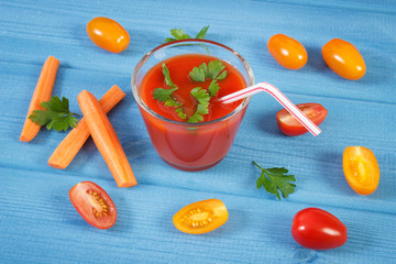 Tomato juice and vegetables with spices on boards, concept of healthy nutrition