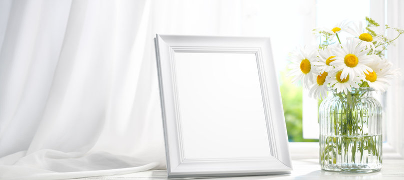  Picture frame near window with flower