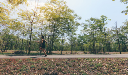 Asian man running in the park in summer.motion blur runner