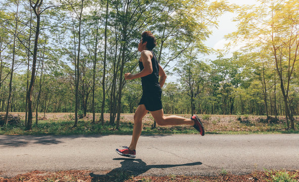Asian man running in the park in summer.motion blur runner
