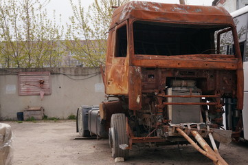 Naklejka na ściany i meble Rusty truck - a tractor after a fire and accident