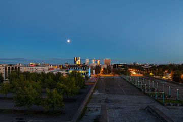 Aerial cityscape of modern business financial district with tall skyscraper buildings illuminated at night. Tallinn, Estonia