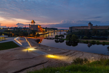 Golden sunset over two medieval fortresses on the river Narva, Estonia and Russia border.