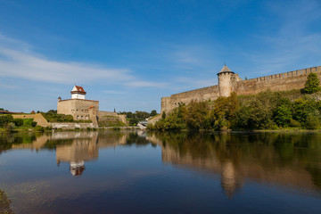 Fototapeta na wymiar Two medieval fortresses on the river Narva, Estonia and Russia border. Summer day view.