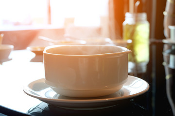 Hot soup in a bowl With the sun in the morning.