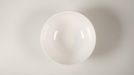 TOP VIEW: White soup bowl on a white table