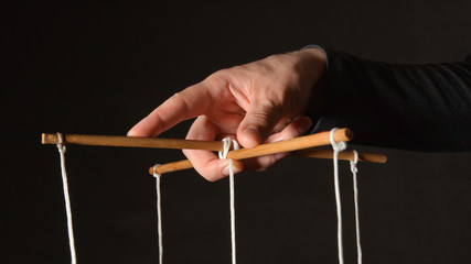 MANIPULATION: Hand of a puppeteer - Close up