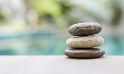 Natural zen stone over blurred background, outdoor day light