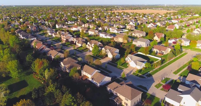 Beautiful suburban neighborhoods, nice homes, aerial view at sunrise.
