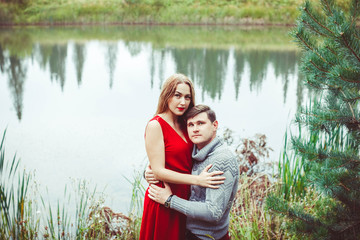 The couple is sitting by the lake