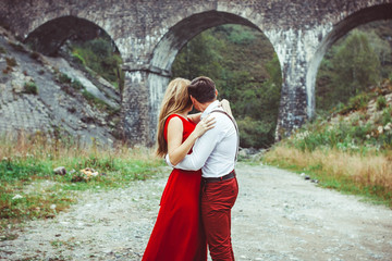 Lovers are standing by the bridge