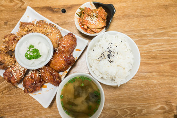 Korean style spicy sauce deep fried chicken wing serve with rice..top view