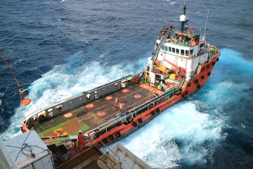 Supply boat transfer cargo to oil and gas industry and moving cargo from the boat to the platform