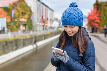 Woman use of cellphone in otaru city