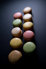 Cake macaron or macaroon isolated on black background, sweet