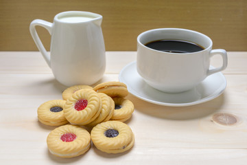 Coffee and biscuits over wooden background