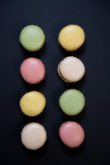 Cake macaron or macaroon isolated on black background, sweet