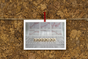 Coaching on business card pinned up on cork board