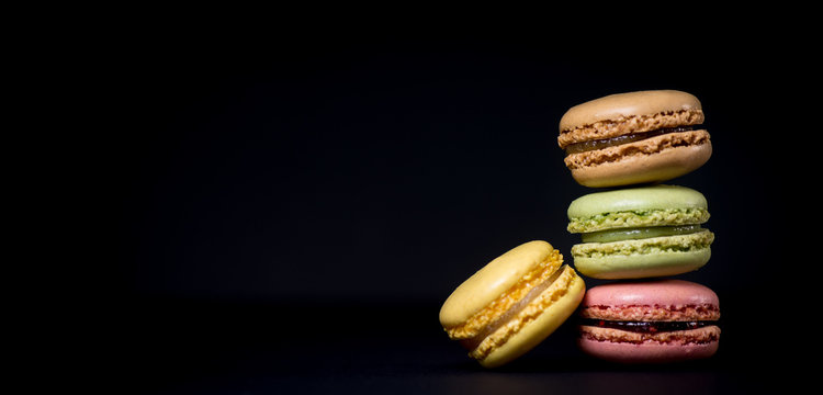 Cake macaron or macaroon isolated on black background, sweet