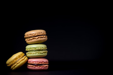 Cake macaron or macaroon isolated on black background, sweet