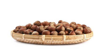 Wicker basket of hazelnuts isolated