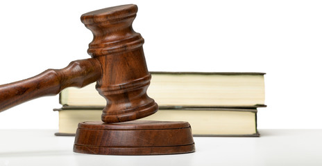 Wooden gavel and books on wooden table