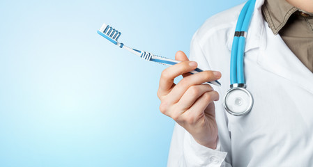 Fototapeta premium dentist hand with toothbrush