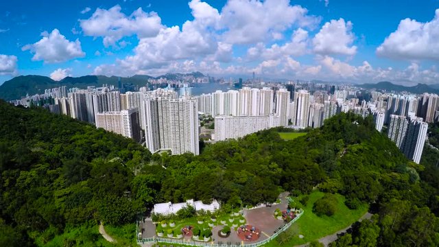 Aerial Hong Kong Wide Shot 4K.
Beautiful 4K aerial shot of Hong Kong of China. Crank up from a green park to the whole Hong Kong Victoria Harbour view. Good for video opening or establishing shot. 
