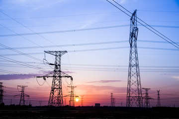 The silhouette of high voltage towers