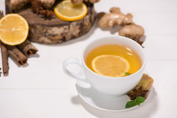 Healthy ginger tea ingredients on a wooden table