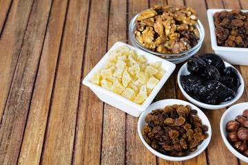 Different dried fruits over wooden background