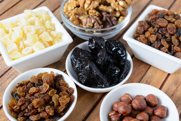 Different dried fruits over wooden background