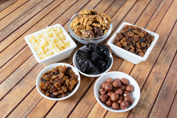 Different dried fruits over wooden background