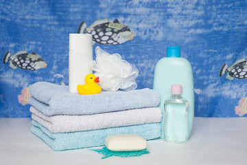 Bath towels, soap, wisp of bast, shower gel, Towels folded stack. The pieces of soap lying in front...