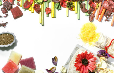 Beauty salon accessories, flat lay design background. Soap, bath salt, washcloth, flower petals, and aroma incense. Top view.