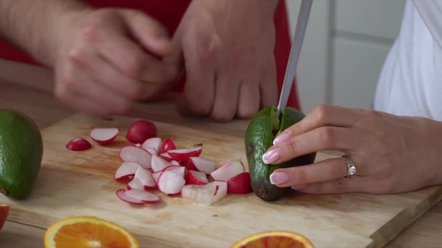 The lovely young family amicably cooks to itself food in the kitchen. Parents Young Son Home Kitchen Tablet App - Young parents son home kitchen using wireless tablet online apps search recipes