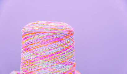 Reels or spools of multicolored sewing threads. Threads of all colors. Shallow depth of field. Close-up macro shot..colorful texture from threads for knitting