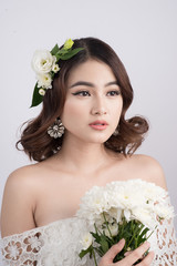 Beautiful asian woman bride on grey background. Closeup portraits with a professional makeup