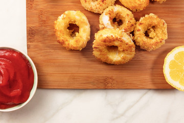 Calamari rings, red sauce, lemon, copyspace
