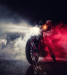 High power motorcycle chopper with man rider at night - obrazy, fototapety, plakaty