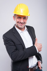 Foreman wearing hardhat making thumb up gesture