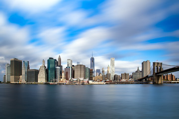 Fototapeta na wymiar Manhattan skyline and Brooklyn Bridge with waves ot the Hudson river