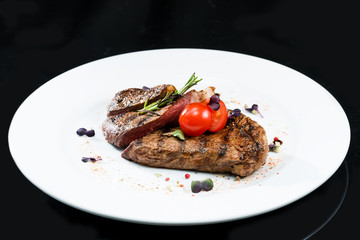 Grilled beef meat on a white plate