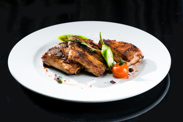 Grilled beef meat on a white plate
