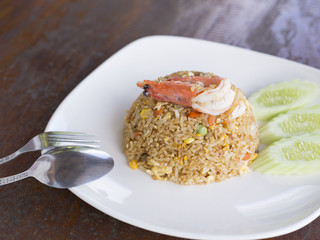 Fried rice with shrimp on wooden table