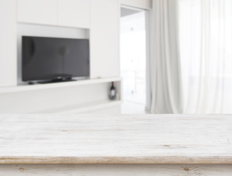 Wooden Table In Front Of Blurred Living Room Interior Background