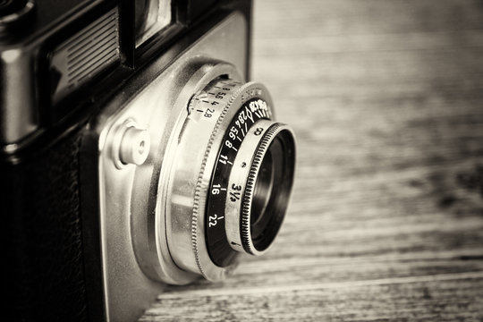 Old vintage retro camera on wooden background